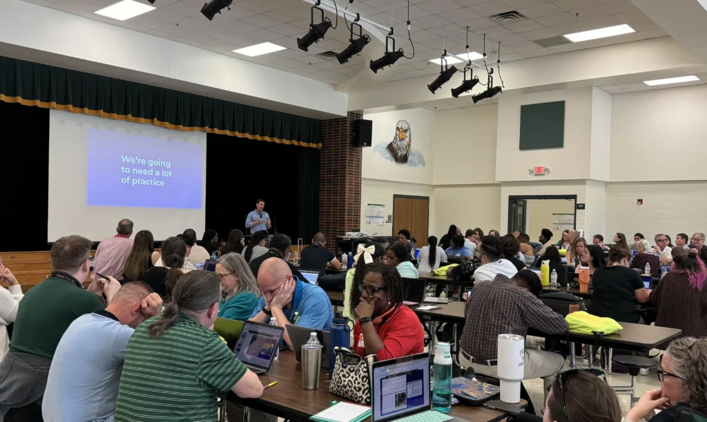 image of Adam Sparks presenting to a cafeteria full of teachers as part of a keynote