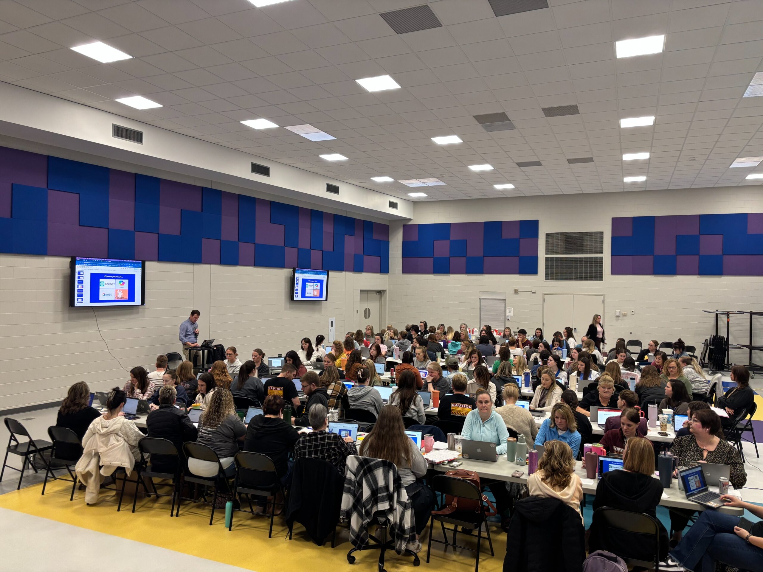 Educators in a gym taking part in a workshop